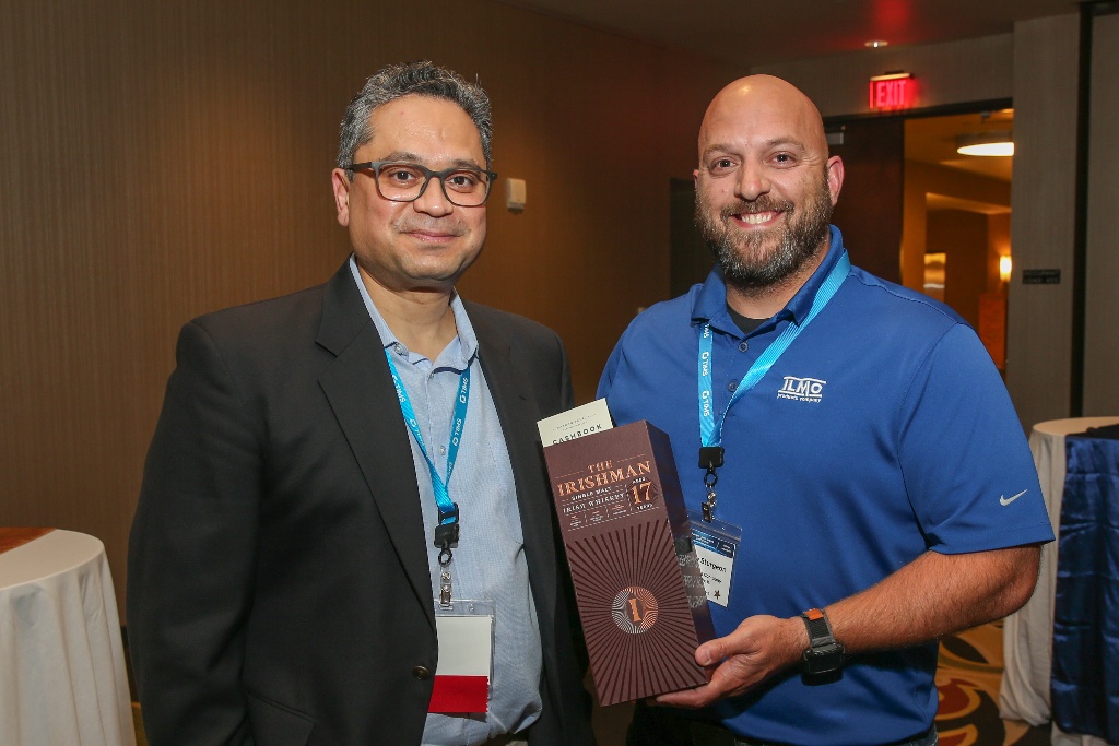 A customer wins a bottle of Irish whiskey from our sponsor, Cashbook.