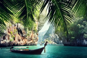 long boat and rocks on beach in Krabi, Thailand